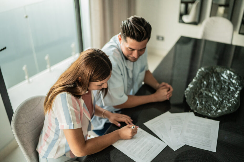 Couple reviewing documents and map of overseas assets in family law context