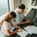 Couple reviewing documents and map of overseas assets in family law context