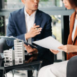 Couple reviewing financial and legal documents for high-value property settlement contributions