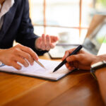 Small business owners reviewing shareholder agreement with lawyer in NSW