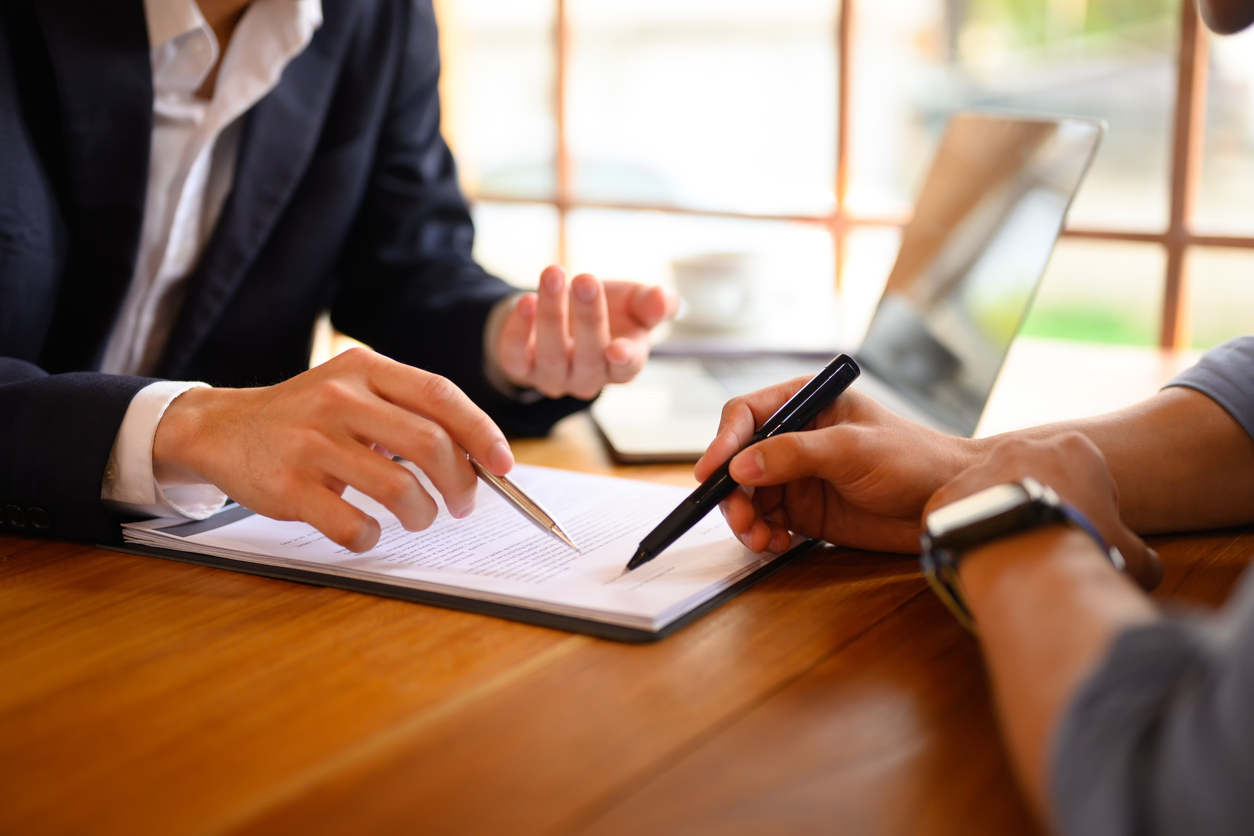 Small business owners reviewing shareholder agreement with lawyer in NSW