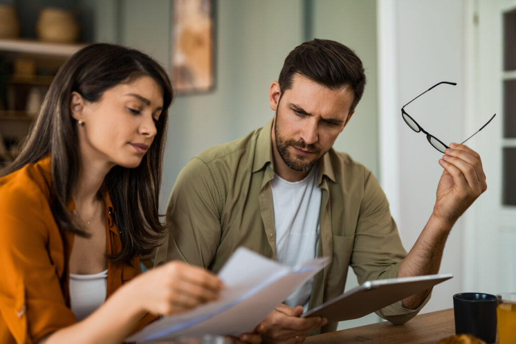 Property buyers discussing settlement delay issues with conveyancing lawyer in NSW